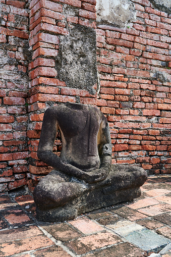 Ancient decapitated Buddha state at Wat Mahathat. Ayutthaya. Phra Nakhon Si Ayutthaya province. Thailand.