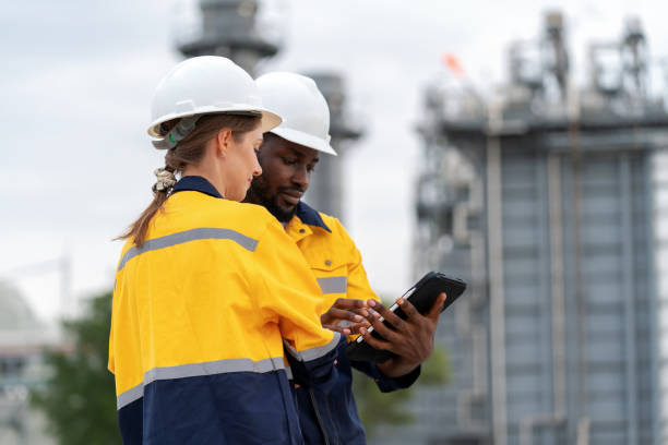 istock Female manager and a field service engineer are engaged in discussion utilizing a tablet to strategize project tasks and follow-up plans during an on-site survey. Driving Continuity, Reliability, and Safety within field service operations. Technology to s 1654883906