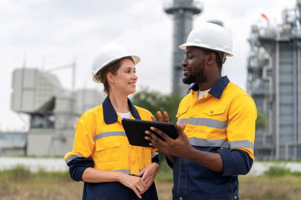 istock Innovation and Quality within the realm of Field Operations, where a dedicated team of surveyors is hard at work. Electrical engineer using computer and discuss with team to increase capacity at power plant. 1654883912