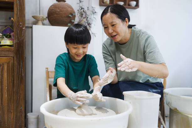 istock Mom and Son Make Pottery Together 1654885621