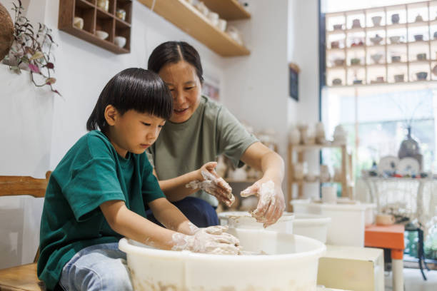 istock Mom and Son Learn to Make Pottery Together 1654885622