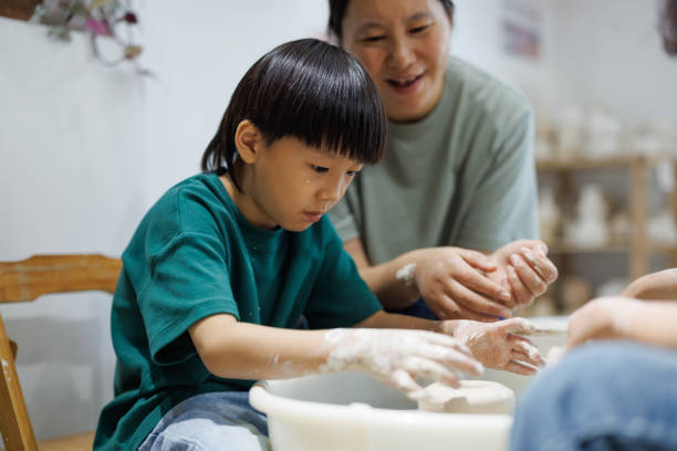 istock Asian mothers and sons learn how to make pottery together 1654886176
