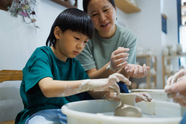 istock Asian mothers and sons learn how to make pottery together 1654886197