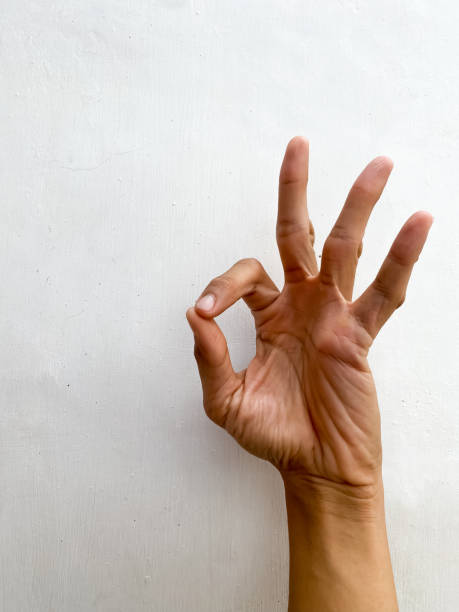 istock Hand showing fingers over isolated white background gesturing approval expression doing okay or OK symbol with fingers. Concept for agreement, fine, clear, done, all is well, good condition, positive emotions. 1654892917