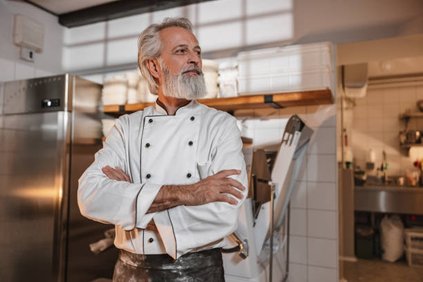 istock Experienced Baker With Arms Crossed Standing In The Bakery Kitchen 1654901383