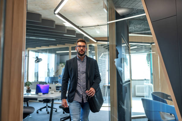 istock Confident Young Executive Walking Through The Corridor Of A Modern Office 1654901984