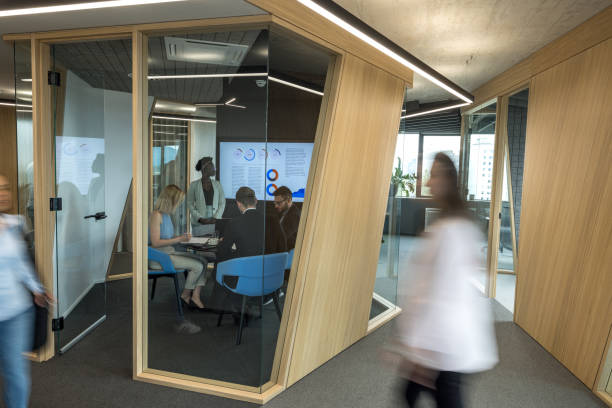 istock Dark-Skinned Female Manager Giving A Presentation To Her Team Inside A Cubicle 1654902598