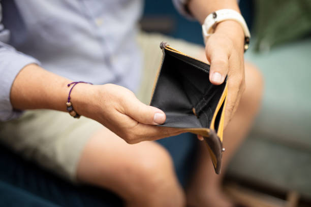 istock Poor woman hand open empty purse looking for money 1654907764