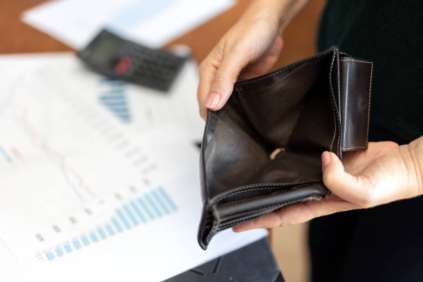 istock Poor woman hand open empty purse looking for money 1654907830