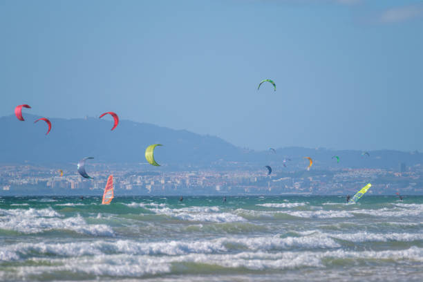 istock Kiteboarding kitesurfing kiteboarder kitesurfer kites on the ocean beach 1654908471