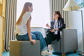 Female psychologist working with young teen girl