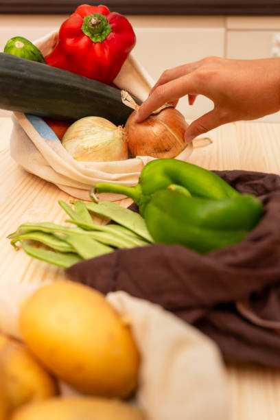 istock A woman's hand picking up vegetables she has bought 1654911839