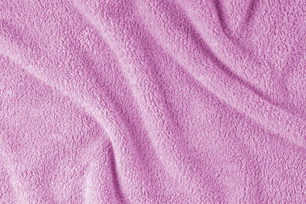 istock Terry cloth, pink towel texture background. Soft fluffy textile bath or beach towel material 1654913790