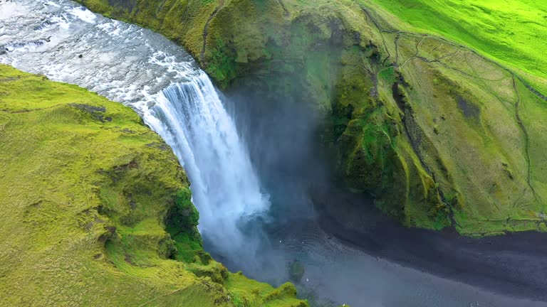 Aerial view of the Skogafoss waterfall, Iceland, flying above with a drone