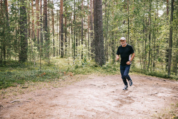 Husband and wife pursuing different outdoor activities in the pine forest and having a healthy active retirement.