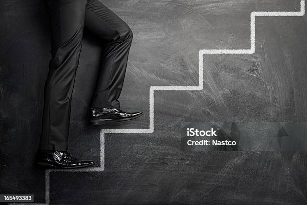 Climbing The Career Stairs Stock Photo - Download Image Now - Stepping, Ladder of Success, Businessman