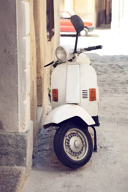 Italian retro scooter in a small street in Tuscany
