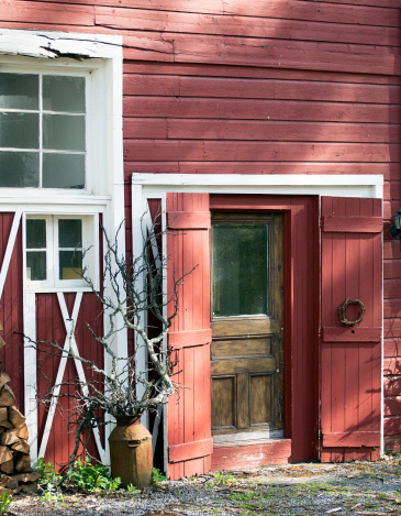Country setting, Barn Doors with sculptural elements in afternoon light.