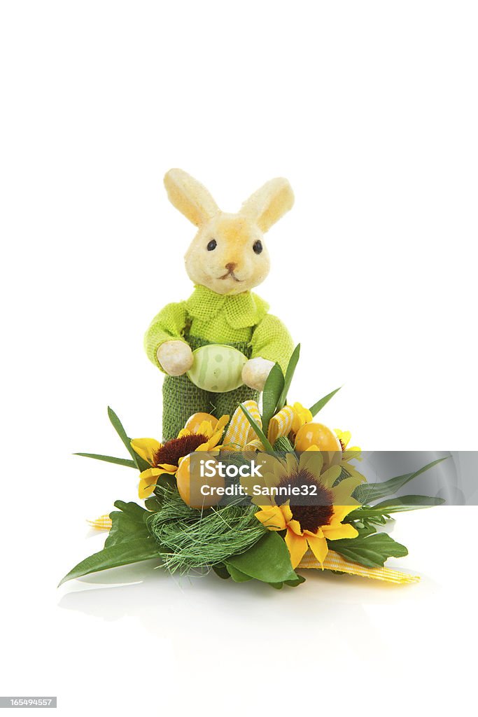 Easter arrangement Easter arrangement with bunny, fake eggs, flowers and leaves over white background Arrangement Stock Photo