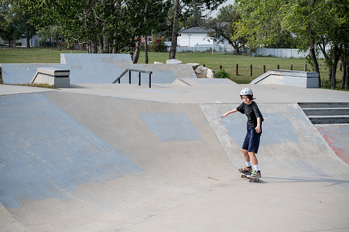 A whirlwind of action and determination as this fearless 15-year-old gender nonconforming teen conquers the ramps at the skate park, showcasing the remarkable power of self-expression and skate culture.