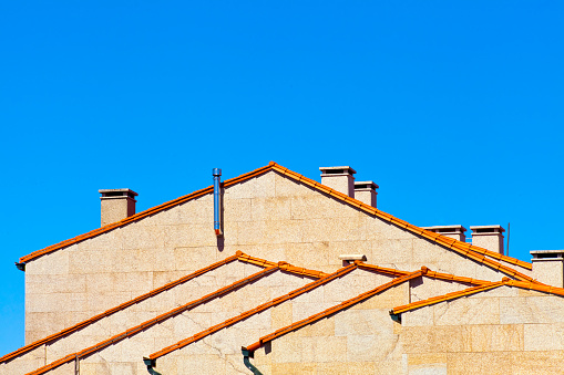 Party walls  in a row side view, rooftops, clear sky. Architecture, abstract view suitable for background purposes. A Coruña province, Galicia, Spain.