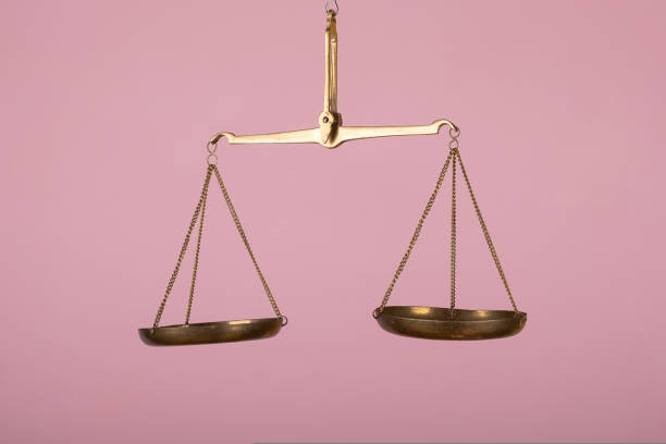 man hand holding a balance on pink background