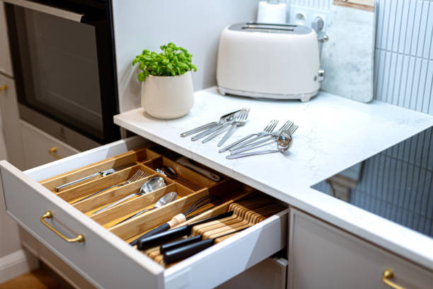 istock Organizing cutlery and kitchenware in kitchen drawer. Storage organization system in kitchen 1654999358