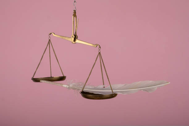 man hand holding a balance on pink background
