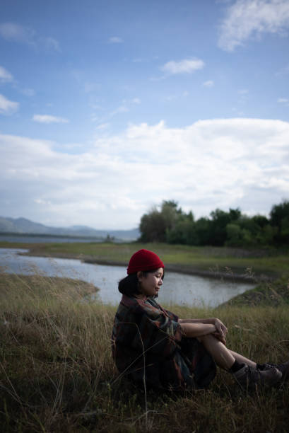 Woman surrounded by nature. She enjoying relaxation in the evening on a sunny day. ,lifestyle concept ,People, lifestyle concept , looking happy , Nature, outdoors