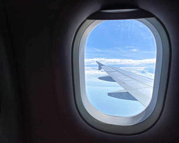 istock Looking through window aircraft during flight in wing with a nice blue sky and islands. The view from the airplane window. Daylight Sunny Bright during the day. 1655028489