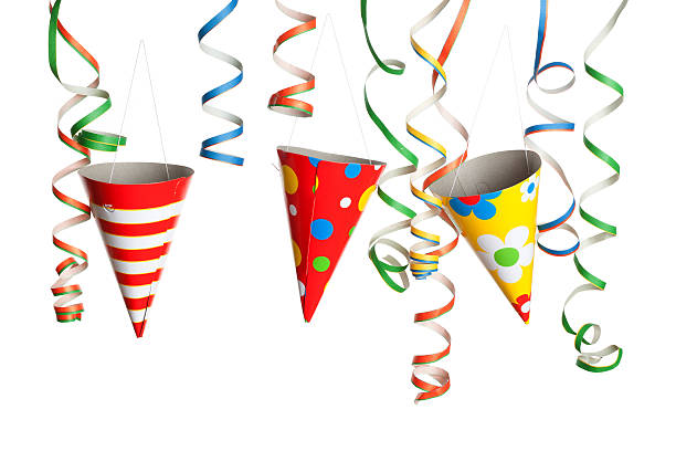 Bunch of party streamers and hats hanging in the air.  Photographed in studio isolated on white background.