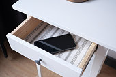 mobile phone in open drawer