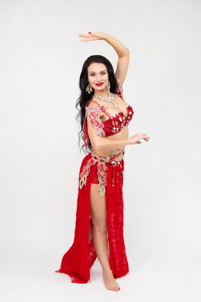 istock A brunette girl in a red dance costume performs oriental dances, a gray background 1655051208