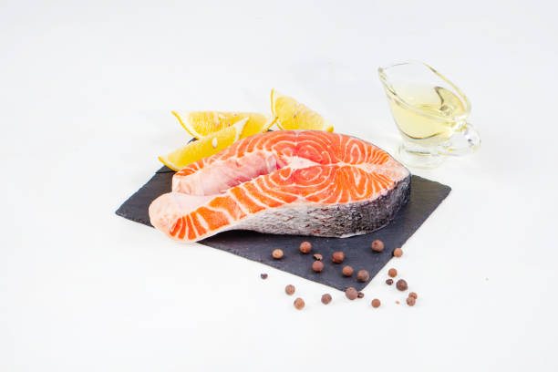 istock Trout steak on a black board with lemon and oil 1655069824