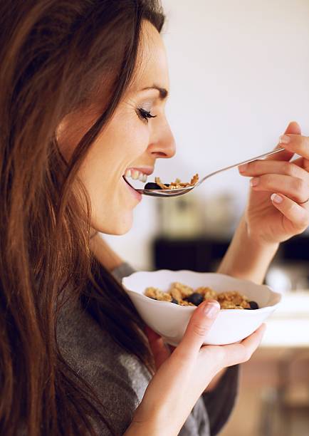 istock Lady Eating Her Cereal Indoors 165507438