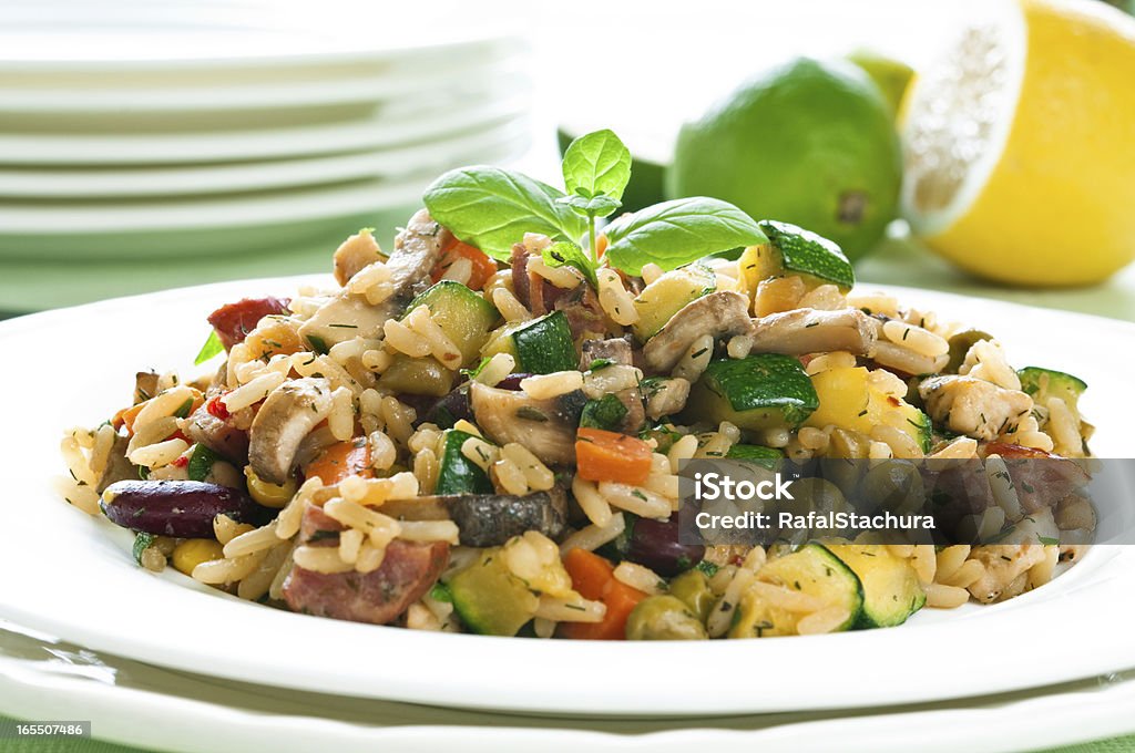 Risotto Risotto with chicken and vegetables on white plate Basil Stock Photo