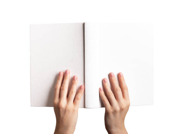 istock Hands holding open book mockup, blank hard cover mock-up isolated on white background 1655090441