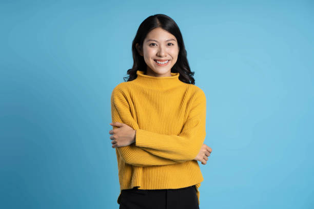 image of young asian girl posing on a blue background