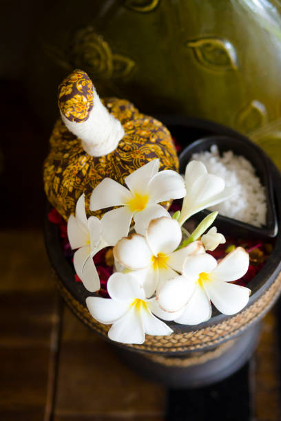 Thai massage stamp and frangipani flowers stock photo