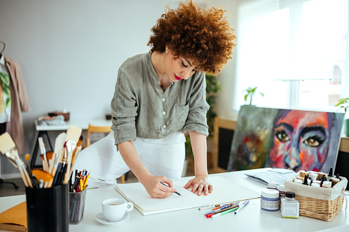 Woman drawing  in her studio