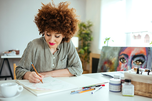 Woman drawing  in her studio