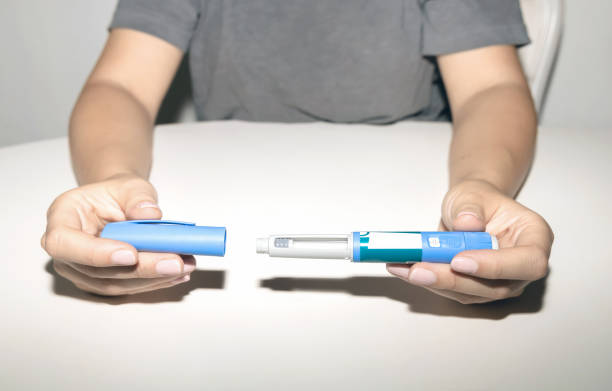 istock Woman holding an injection pen for diabetic. 1655115686