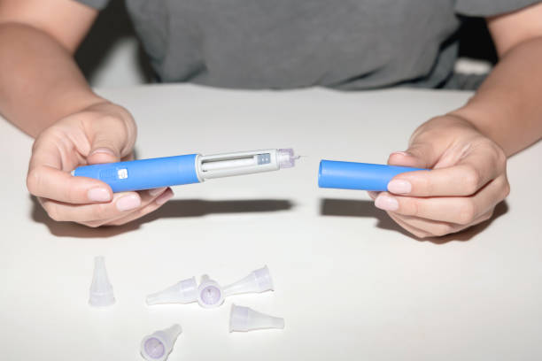 istock Woman holding an injection pen for diabetic. 1655115870