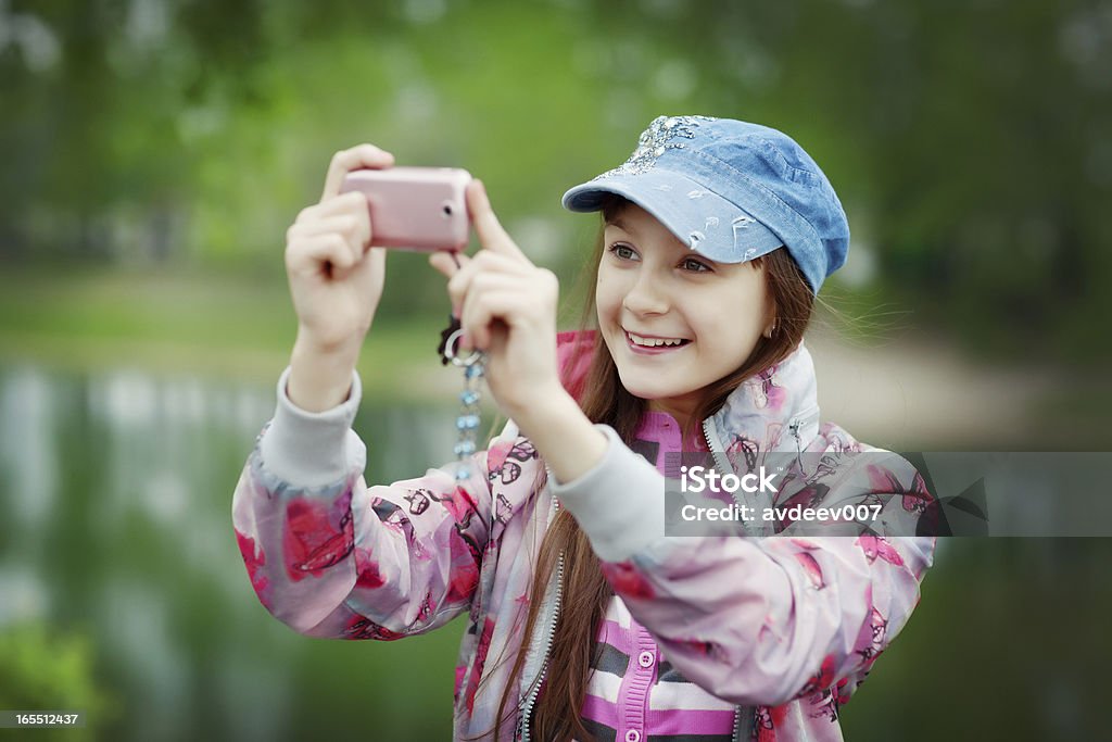 Young photographer Girl taking pictures on cell phone. Adobe RGB 10-11 Years Stock Photo