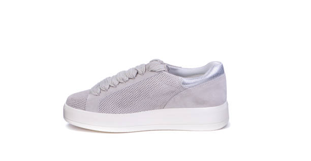 istock Stylish gray perforated suede women's sneaker with a white sole, displayed on a white background with copy space. Fashionable stylish sports casual shoes. Footwear sales advertising campaign. 1655126094