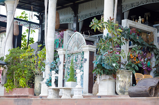 Decorated detail of อัมพวาศรี คาเฟ่ : Amphawa Sri Cafe seated at river in outer area of old town and floating market. Mix of classical 19th century style and plants