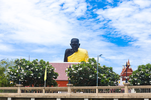Black thai buddha statue of Wat Bang Kapom in Amphawa seated at Mae Khlong river seen from river