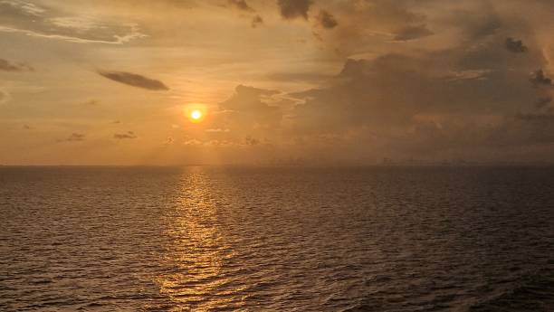 istock Wide angle Golden sunset over ocean with dramatic clouds in blue sky September 2023 1655213306