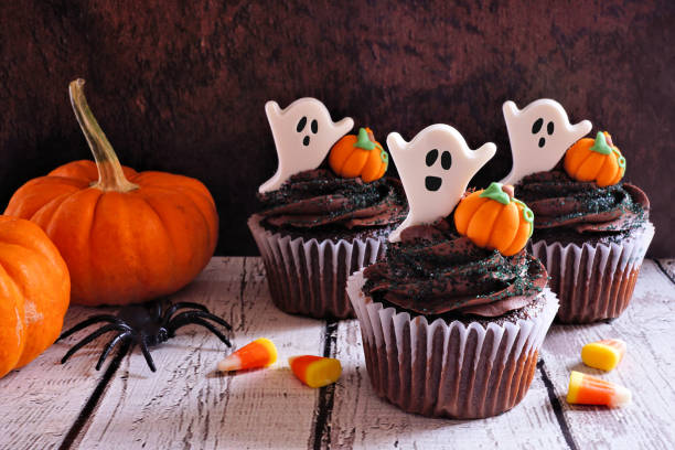 istock Halloween chocolate cupcakes with ghosts and pumpkins, table scene 1655225223