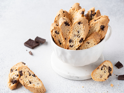 Italian classic biscotti with dark chocolate chips and orange zest. Close up view. Homemade crunchy biscuits. Delicious snack, dessert or breakfast.